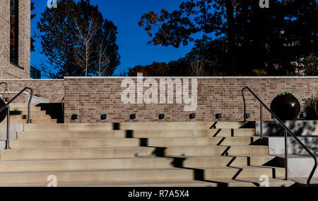 Shadows travel down a concrete  stairway outside. Stock Photo