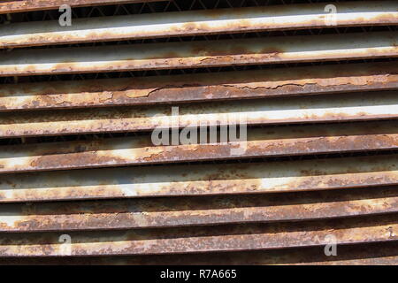 A brick wall with a rusty iron grille Stock Photo