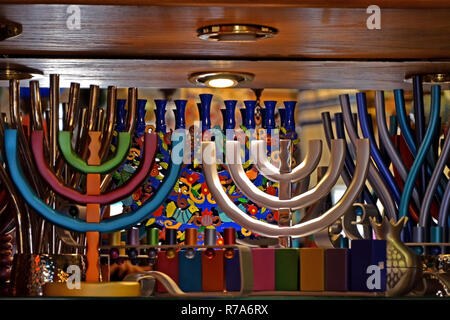 Colorful festive menorah and multi-colored jewish candlesticks on the shop window in Jerusalem, Israel. Stock Photo