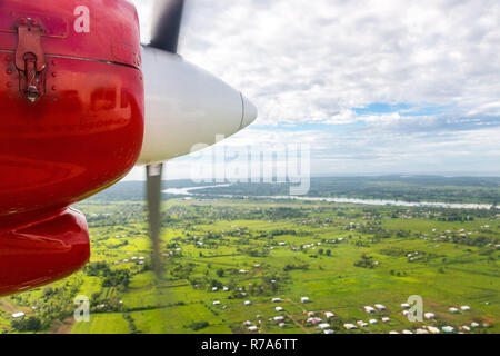 Air travel in Fiji, Melanesia, Oceania. View of Rewa river, Nausori town, Viti Levu island from a window of a small turboprop propeller airplane. Stock Photo