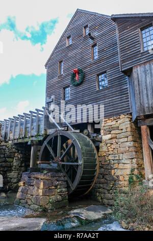 Old watermill decorated with a holiday wreath for Christmas at Historic Yates Mill County Park in Raleigh North Carolina Stock Photo