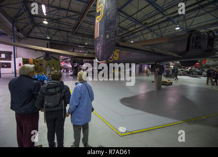 RAF Museum, London, UK. 8 December, 2018. To celebrate 100 years since the formation of the RAF, RAF Museum London offer visitors the last chance to get a closer look inside 14 cockpits and vehicles from the RAF Museum collection including a Hawker Hurricane, Hawker Typhoon, Liberator, Stuka and Bristol Beaufort. Visitors walk around the iconic Avro Lancaster (not included in the cockpit event). Credit: Malcolm Park/Alamy Live News. Stock Photo