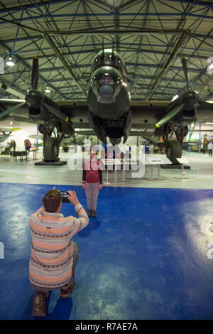 RAF Museum, London, UK. 8 December, 2018. To celebrate 100 years since the formation of the RAF, RAF Museum London offer visitors the last chance to get a closer look inside 14 cockpits and vehicles from the RAF Museum collection including a Hawker Hurricane, Hawker Typhoon, Liberator, Stuka and Bristol Beaufort. Visitors walk around and admire the iconic Avro Lancaster (not included in the cockpit event). Credit: Malcolm Park/Alamy Live News. Stock Photo