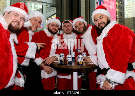 New York, New York, USA. 8th Dec, 2018. Santa Con, the city-wide annual bar crawl got off to an early 10:00 am local-time start in mid-town Manhattan. After a group photo, revelers headed to bars, pubs, strip clubs, karaoke spots and raves who are participating in the seasonally Yuletide bacchanal. Credit: G. Ronald Lopez/ZUMA Wire/Alamy Live News Stock Photo