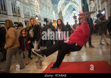 Malaga, Spain. 8th Dec, 2018. An artist performs on the street while people seen walking during the christmas season. Credit: Jesus Merida/SOPA Images/ZUMA Wire/Alamy Live News Stock Photo