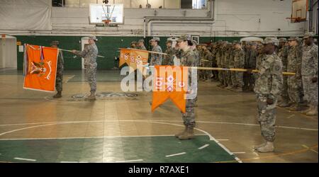 U.S. Army Soldiers of the 101st Expeditionary Signal Battalion, New York Army National Guard, stand at attention as Maj. Ian Seagriff assumes command of the battalion from outgoing commander Lt. Col. Diane Armbruster at the Police Athletic League Center, Yonkers, N.Y., April 9, 2017. Stock Photo