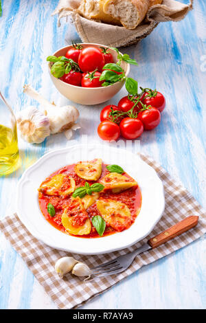 delicious pasta - ravioli in tomato sauce with basil Stock Photo
