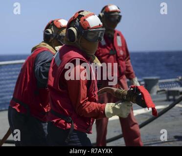 U.S. Navy sailors perform a crash and salvage drill on the USS Arleigh ...