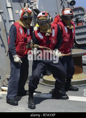 U.S. Navy sailors perform a crash and salvage drill on the USS Arleigh ...