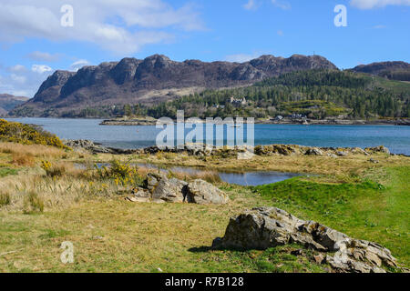 View across Loch Carron to Duncraig Castle and distant crags from Plockton Village, Highland Region, Scotland Stock Photo