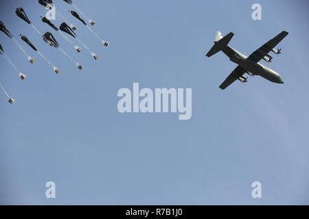 Low cost aerial delivery systems, each loaded with four, 55-gallon drums of water, are dropped from a Republic of Korea Air Force C-130, April 12, 2017, onto a drop zone between Daegu and Busan, South Korea. ExOPR17 focuses on integrating Republic of Korea and U.S. Alliance logistics capabilities within air, land, maritime, space and information environments. Stock Photo
