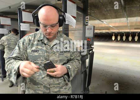 Staff Sgt. Burt Perry, 88th Security Forces Squadron operations staff non-commissioned officer, loads his 20-round magazine prior to shooting in the pistol and rifle Excellence in Competition contest at the 88th Security Forces Squadron firing range, Apr. 12, 2017, at Wright-Patterson Air Force Base, Ohio. The Apr. 3-13 EIC event conducted Air Force-wide was open to all active duty, Guard, Reserve, retiree and civil service employees. Stock Photo