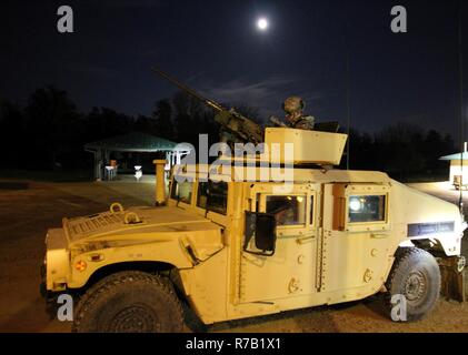 U.S. Army Reserve Soldiers with 325th Psychological Operations Company (Airborne), U.S. Army Civil Affairs and Psychological Operation Command, wait to complete basic night live-fire during Operation Cold Steel at Fort McCoy, Wis., April 11, 2017. Operation Cold Steel is the U.S. Army Reserve's crew-served weapons qualification and validation exercise to ensure that America's Army Reserve units and Soldiers are trained and ready to deploy on short-notice and bring combat-ready and lethal firepower in support of the Army and our joint partners anywhere in the world. Stock Photo