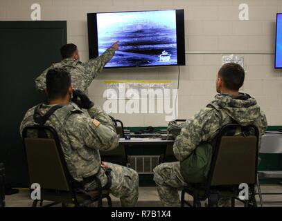 U.S. Army Reserve Soldiers with 325th Psychological Operations Company (Airborne), U.S. Army Civil Affairs and Psychological Operation Command, identify targets on a thermal image during Operation Cold Steel at Fort McCoy, Wis., April 11, 2017. Operation Cold Steel is the U.S. Army Reserve's crew-served weapons qualification and validation exercise to ensure that America's Army Reserve units and Soldiers are trained and ready to deploy on short-notice and bring combat-ready and lethal firepower in support of the Army and our joint partners anywhere in the world. Stock Photo