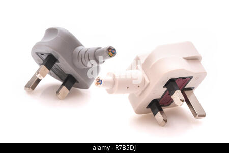 Two cut off 13 amp mains plugs on a white background Stock Photo