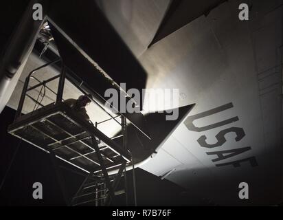 U.S. Air Force Airmen with the 8th Expeditionary Air Mobility Squadron perform a post-flight inspection on a C-17 Globemaster III at Al Udeid Air Base, Qatar, May 4, 2017. The inspection being performed on the C-17 Globemaster III is accomplished on a regular schedule in order keep the aircraft mission ready. Stock Photo