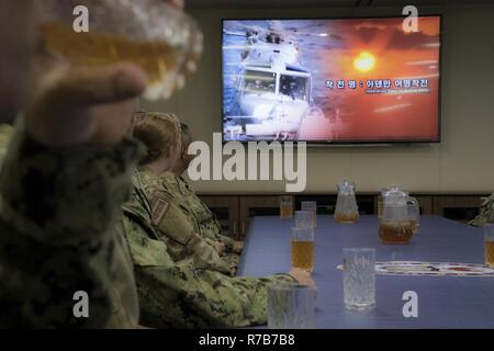 South Korean Navy Capt. Kim Kyung-Ryul, Commander of the ROKS Choi-Young DDH-981, serves traditional tea to Combined Joint Task Force-Horn of Africa members who joined members of Camp Lemonnier, Djibouti, in a visit to Republic of Korea Ship Choi Young DDH-981, May 8, 2017. The ship is a Chungmugong Yi Sun-sin-class destroyer in the South Korean navy. Stock Photo