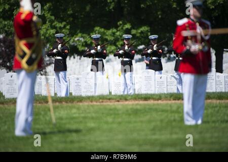 Marines from Marine Barracks Washington perform a three rifle volley during the graveside service for Marine Corps Reserve 1st Lt. William Ryan, in Arlington National Cemetery, Arlington, Va, May 10, 2017.  Declared deceased as of May 11, 1969, Ryan’s remains from the Vietnam War were missing until identified by Defense POW/MIA Accounting Agency (DPAA) in 2016 from an excavated crash site near Ban Alang Noi, Laos. Ryan’s remains were repatriated in Section 60. Stock Photo