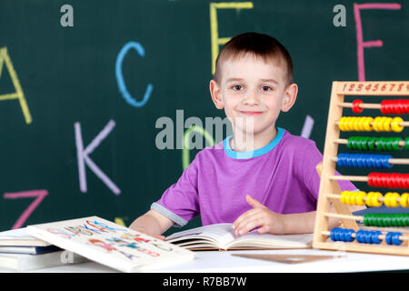 The boy goes to the first class at the school board Stock Photo