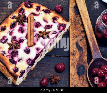 baked pie from cottage cheese and cherry berries on a brown board Stock Photo