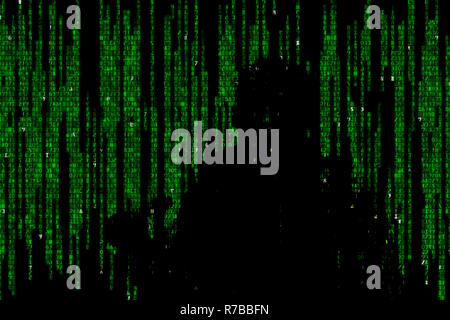 Silhouette of man in green digital data. The symbol of a hacker. Stock Photo