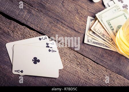 three, seven, ace playing card combination on a wooden table Stock Photo