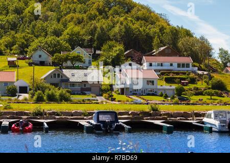 traditional norwegian wooden house to stand at the lakeside and mountains in the distance, norway Stock Photo