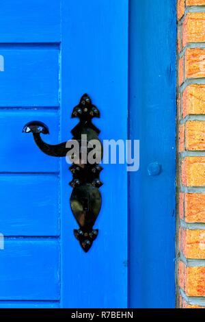 beautiful doorhandle on a blue  wooden door Stock Photo