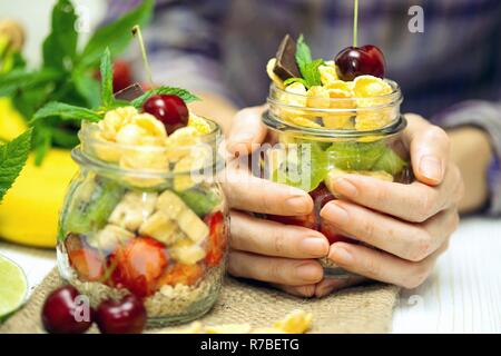 healthy diet. girl holding oatmeal with berries and fruits Stock Photo