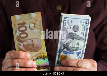 Banknotes of canadian currency Dollar and North American Currency US Dollars. Old retired person paying in cash Stock Photo Alamy