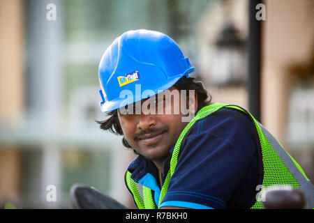 Construction Worker wearing a Hard Hat Safety helmet on a construction site in Dubai,UAE Stock Photo