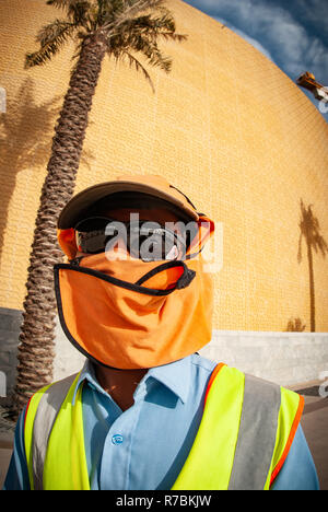 Worker wearing sunglasses with hats and head covering on a construction site in Dubai, UAE Stock Photo