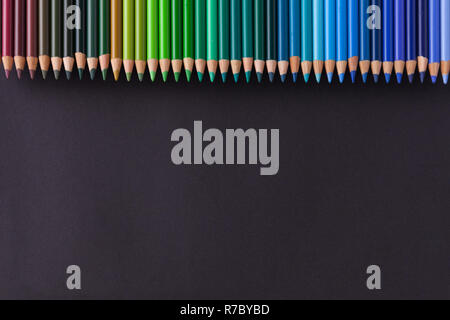 Set Of Colored Pencils of cold tones On A Black Backgroun Stock Photo