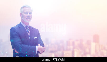 Portrait of senior businessman in front of big modern city Stock Photo