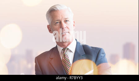 Portrait of senior businessman in front of big modern city Stock Photo