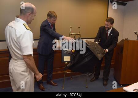 WASHINGTON (May 16, 2017) John Hickenlooper, Governor of Colorado, and Christian Anschutz (right), Managing Director of Western Development Group, unveil a plaque with the crest of USS Colorado (SSN 788) to Rear Adm. William R. Merz, director, Undersea Warfare Division, at the Pentagon. Colorado was christened in December 2016 and will be commissioned in the spring of 2017. Stock Photo