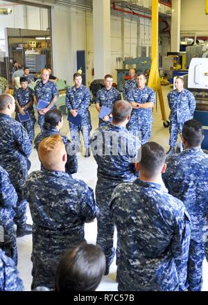 (POLARIS POINT, Guam) May 16, 2017 -- Rear Adm. Stephen Williamson, Director of Fleet Maintenance, U.S. Pacific Fleet, addresses Sailors about the importance of their technical expertise and skills at the Polaris Point Emergent Repair Facility, May 16. Williamson toured the ship and other repair facilities in Guam to assess current operations and capabilities. Land and USS Frank Cable (AS 40), the U.S. Navy’s only two submarine tenders, are both homeported in Apra Harbor, Guam, and provide maintenance, hotel services, and logistical support to submarines and surface ships in the U.S. 5th and 7 Stock Photo