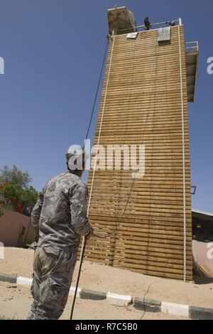 A member of the Royal Jordanian Navy conducts repelling training in support of Exercise Eager Lion 2017. Eager Lion is an annual U.S. Central Command exercise in Jordan designed to strengthen military-to- military relationships between the U.S., Jordan and other international partners. This year's iteration is comprised of about 7,200 military personnel from more than 20 nations that will respond to scenarios involving border security, command and control, cyber defense and battlespace management. Stock Photo