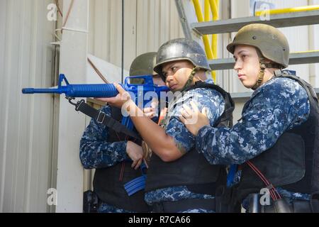 NORFOLK (May 4, 2017) Sailors assigned to the aircraft carrier USS George Washington’s (CVN 73) security reaction force wait to enter the ship’s floating accommodation facility during an anti-terrorism training team evolution involving an active shooter drill. George Washington is homeported in Norfolk preparing to move to Newport News, Virginia for the ship’s refueling and complex overhaul (RCOH) maintenance. Stock Photo