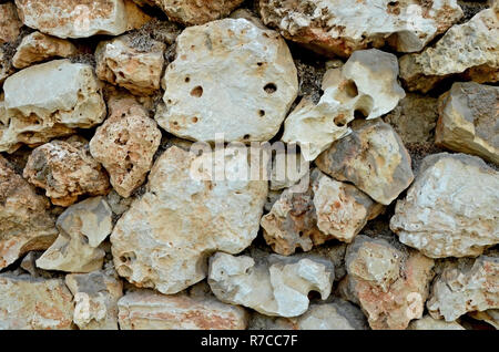 Wall of large stones. The texture of light sandstone. Stock Photo