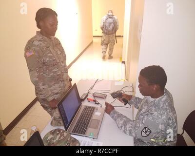 Spc. Jamilya Christopher, 610th Quartermaster Company, in-processes Pvt. Nia David, 631st Engineer Company, at the JRSOI site at the Leonard B. Francis Readiness Center on St. Thomas, May 14. The JRSOI is the in-processing point for all military personnel participating in Vigilant Guard 17-03, national disaster response exercise being conducted in the U.S. Virgin Islands, May 15-19, hosted by the Virgin Islands National Guard and U.S. Northern Command. Stock Photo