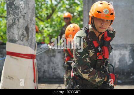 Members of the Armed Forces of the Philippines pull a patient up a vertical wall    using a three-to- one rope rescue system during a subject matter expert exchange in    support of Balikatan 2017 at Fort Magsaysay in Santa Rosa, Nueva Ecija, May 7,    2017. These skills ensure that first responders and military members can secure    and remove victims during a real-life crisis. Balikatan is an annual U.S.-Philippine    bilateral military exercise focused on a variety of missions, including humanitarian    assistance and disaster relief, and counterterrorism. Stock Photo