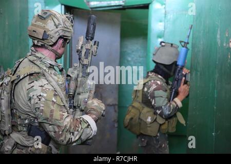 Philippine and U.S. special operations forces soldiers paddle a Stock ...