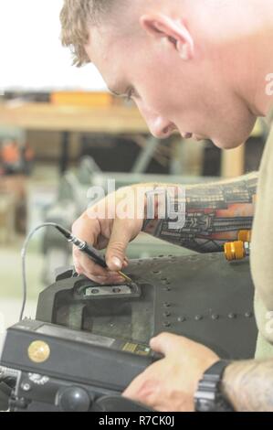 A U.S. Army aircraft powertrain repairer assigned to Company D, 1st ...