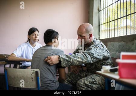 U.S. Army SPC. Randall Ermer screens Honduran patients for medical problems at a Medical Readiness Training Exercise site at Cooperativa village, Colon, Honduras , Apr. 20, 2017. Joint Task Force – Bravo Medical Element, provided care to more than 850 patients during a Medical Readiness Training Exercise in Cooperativa village, Colon, Honduras, Apr. 20-21, 2017. MEDEL also supported a Military Partnership Engagement and assisted more than 650 patients with the Hondurian Navy in Santa Rosa de Aguan, Colon, Honduras, Apr. 22, 2017. Stock Photo