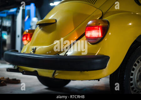 Close up of yellow classic car in workshop interior Stock Photo