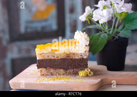 Delicious mango cake on wood with flower Stock Photo