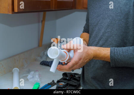 hands plumber at work in install a kitchen sink, plumbing repair service, assemble and install Stock Photo