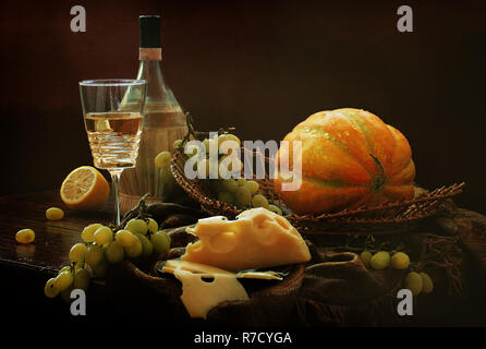 Still life with white wine, cheese and melon Stock Photo