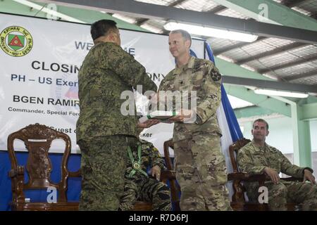 Philippine Army Laurence Col. Mina presents U.S. Army Lt. Col. Ted Kleisner certificates of commendation during the closing ceremony of Balikatan 2017 at Fort Magsaysay in Santa Rosa, Nueva Ecija, May 18, 2017. Mina is the deputy assistant chief of staff for Training and Education Staff, Philippine Army, and Kleisner is the commander of 1st Battalion, 23rd Infantry Regiment. Balikatan is an annual U.S.-Philippine bilateral military exercise focused on a variety of missions including humanitarian and disaster relief, counterterrorism, and other combined military operations. Stock Photo